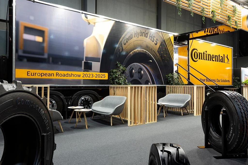 Continental stand at Matexpo Kortrijk with branded trailer, tyres and timber-slat seating area