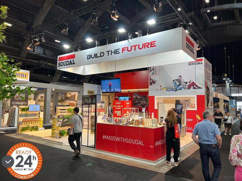 Soudal stand with red counter and white 'Build the Future' fascia, with com2com 'Ready 24h' badge