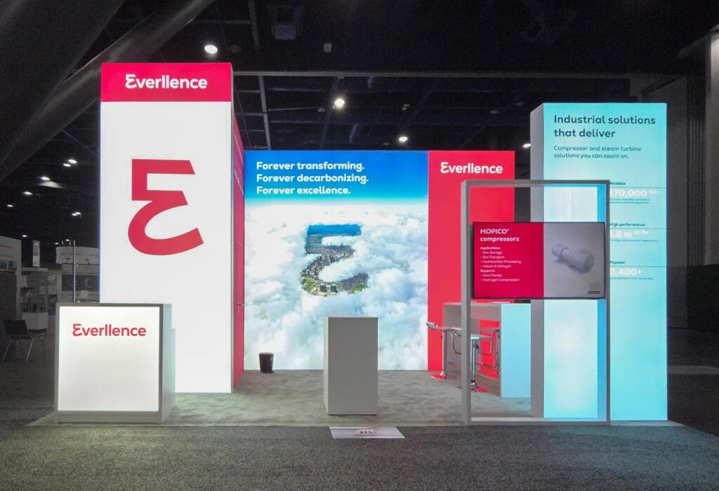 Everllence booth with tall backlit red and white towers, cloud graphic wall and compressor display screen