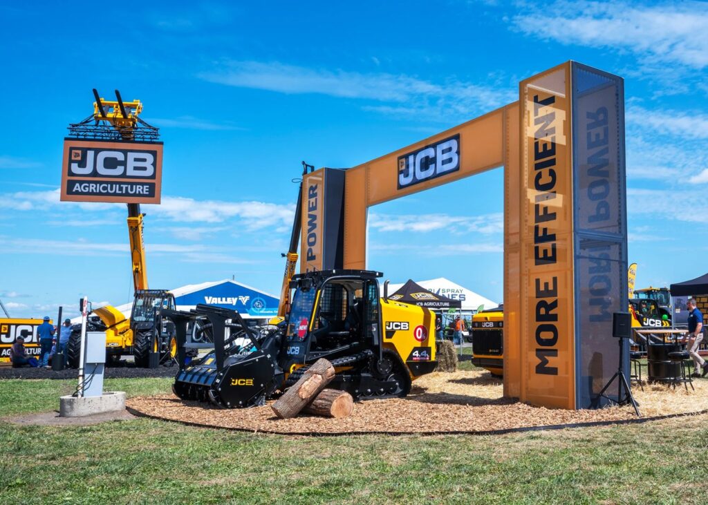 JCB outdoor display at Farm Progress 2025 with an orange archway and tracked machinery