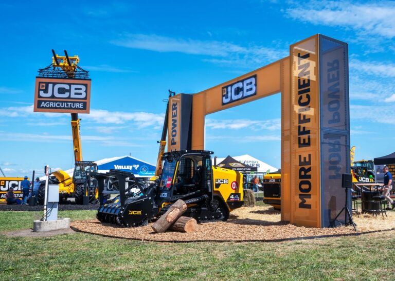 JCB outdoor display at Farm Progress 2025 with an orange archway and tracked machinery